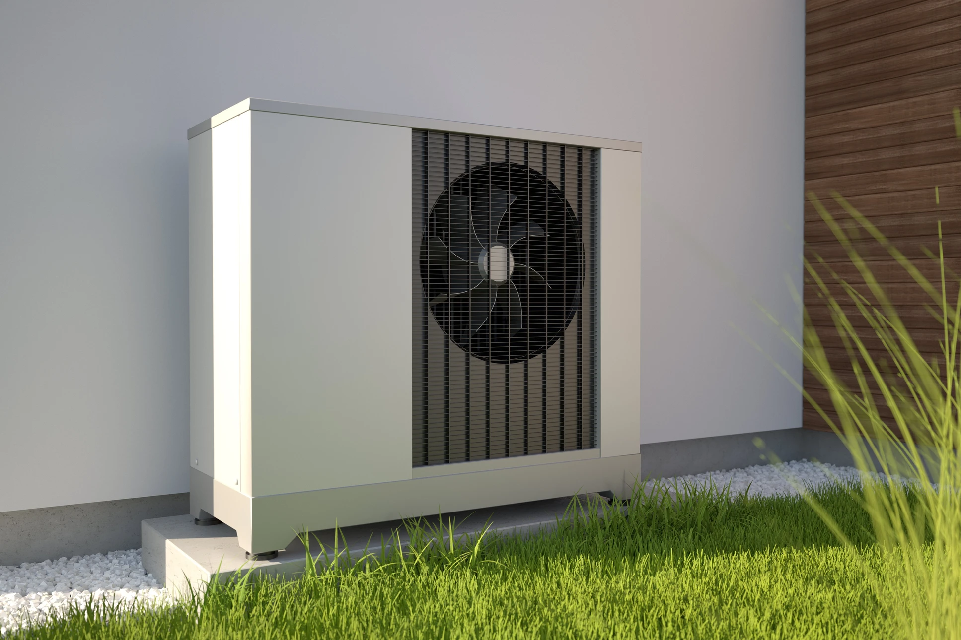 Deux pompes à chaleur air-eau installées à l'extérieur d'une maison moderne avec bardage bois vertical
